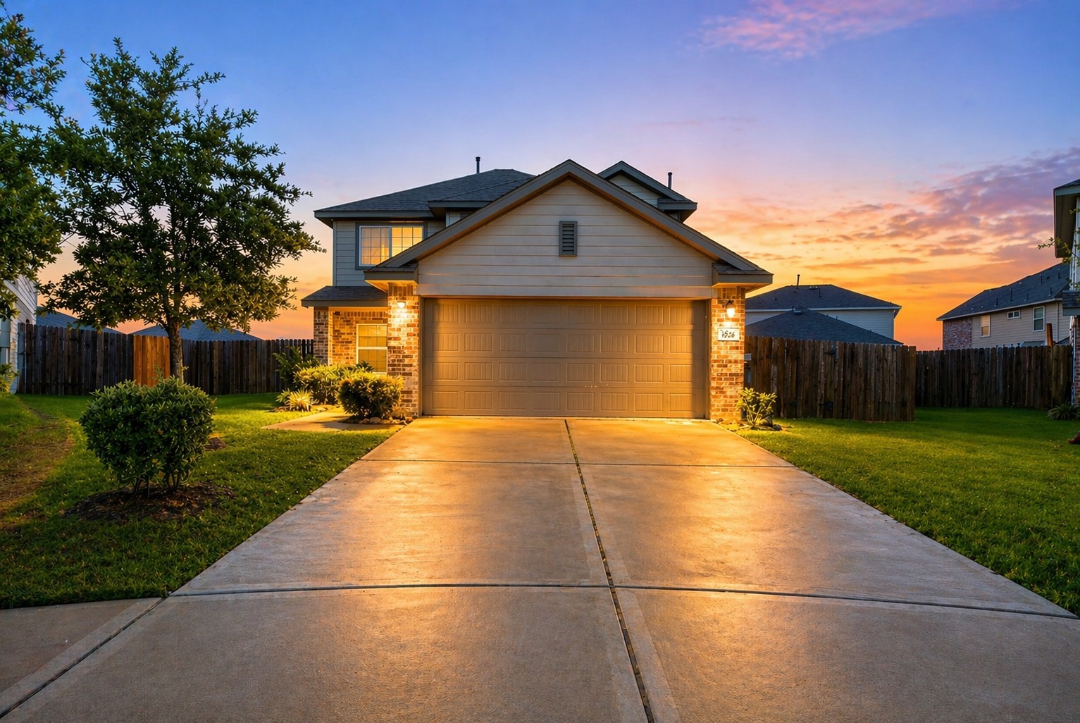 Enjoy peaceful evenings with this warm and inviting sunset view of the home’s front exterior.