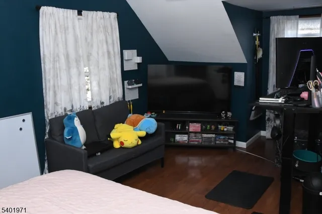 a room with table chairs and flat screen tv