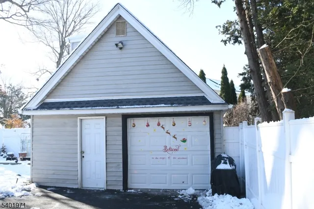 a front view of a house with a tree