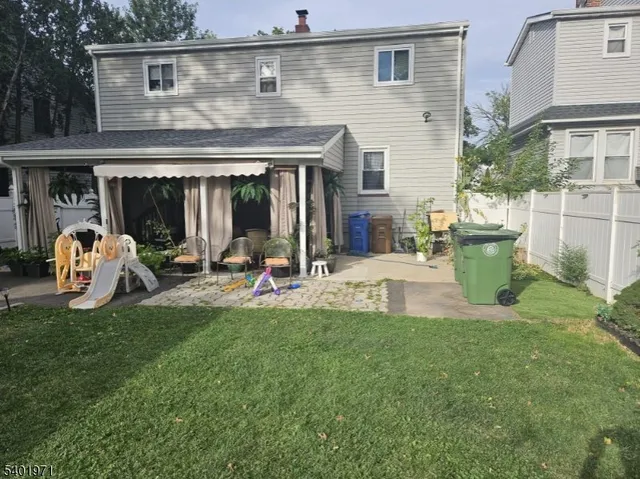 a view of a house with a backyard