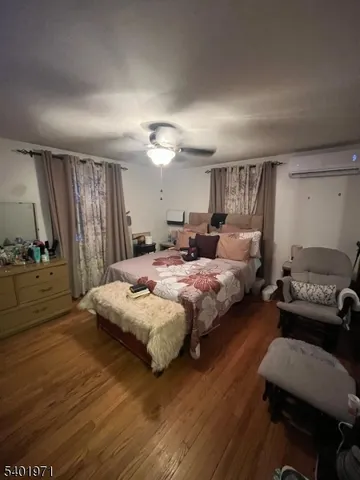 a bedroom with a bed window and a couch