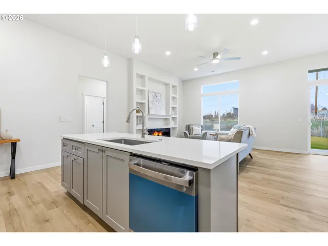 a kitchen with a sink a center island and cabinets