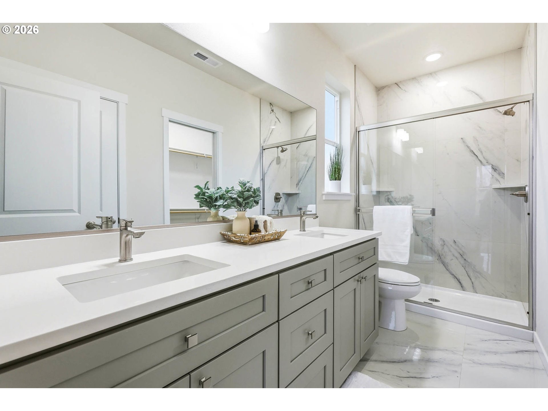 1327 Southeast 9th Street Hermiston, OR 97838 - Photo 20 of 28 a bathroom with a double vanity sink toilet and a mirror