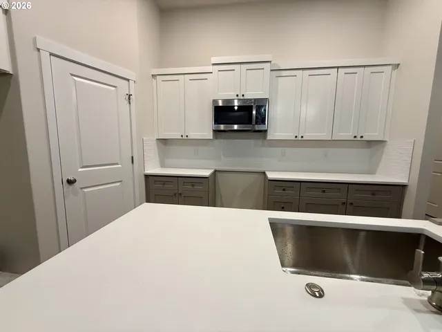 a kitchen with a cabinets and white appliances