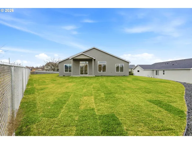 a big house with a big yard and large trees