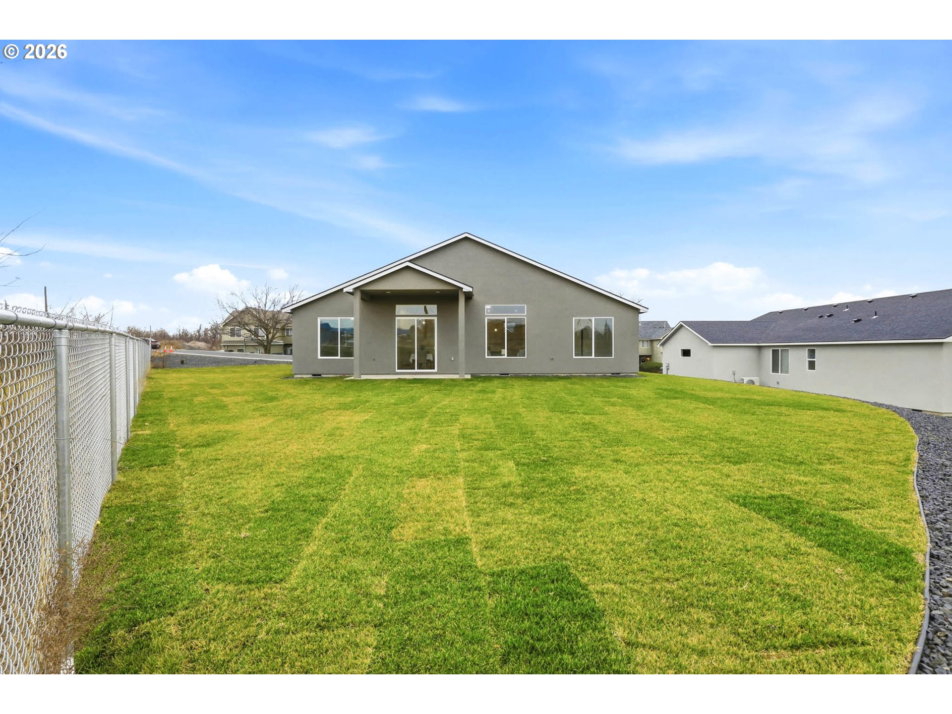 1327 Southeast 9th Street Hermiston, OR 97838 - Photo 24 of 28 a big house with a big yard and large trees