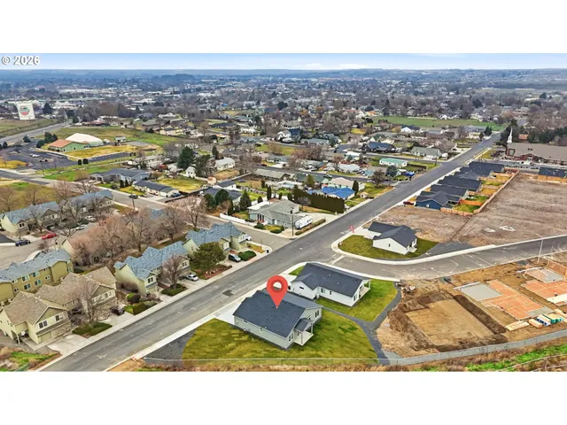 an aerial view of residential houses with outdoor space