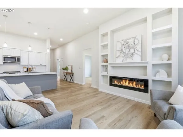 a living room with furniture and a wooden floor