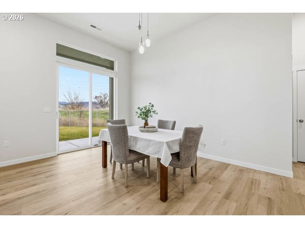 1327 Southeast 9th Street Hermiston, OR 97838 - Photo 9 of 28 a view of a dining room with furniture and wooden floor