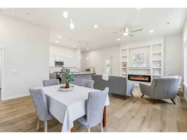 a dining room with furniture and wooden floor