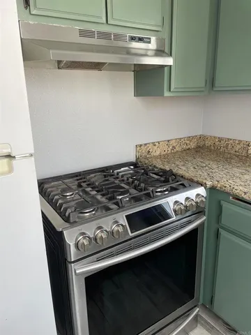 a stove top oven sitting inside of a kitchen