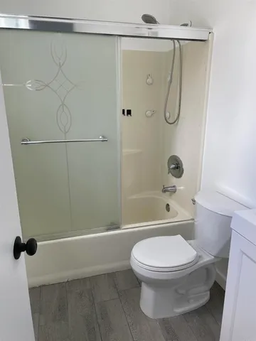 a bathroom with a toilet and a shower