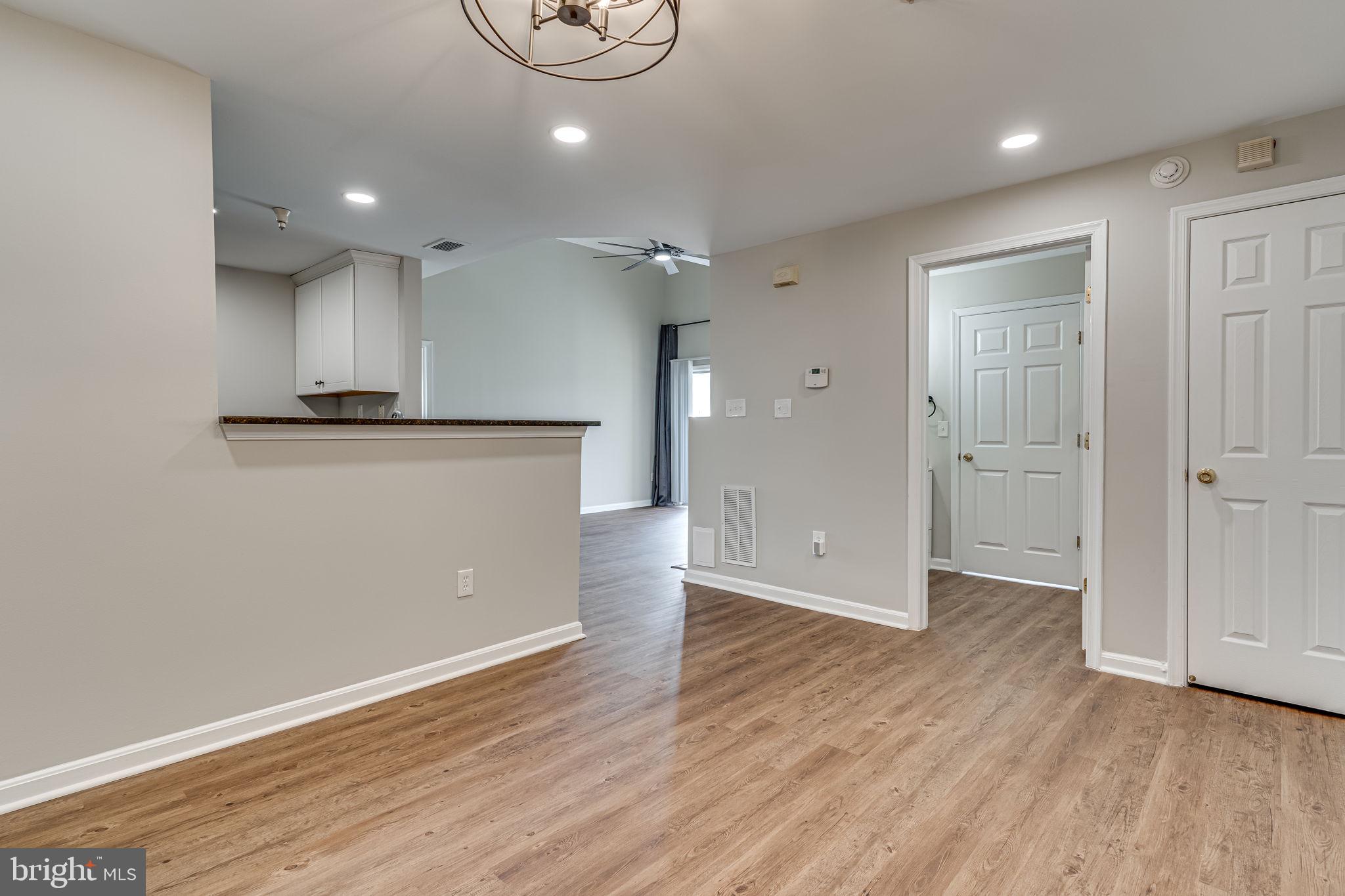 1067 Gardenview Loop, Unit 304 Woodbridge, VA 22191 - Photo 14 of 36 an empty room with wooden floor and windows