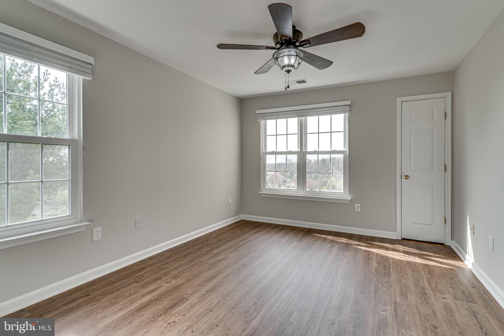 1067 Gardenview Loop, Unit 304 Woodbridge, VA 22191 - Photo 18 of 36 wooden floor in an empty room with a window
