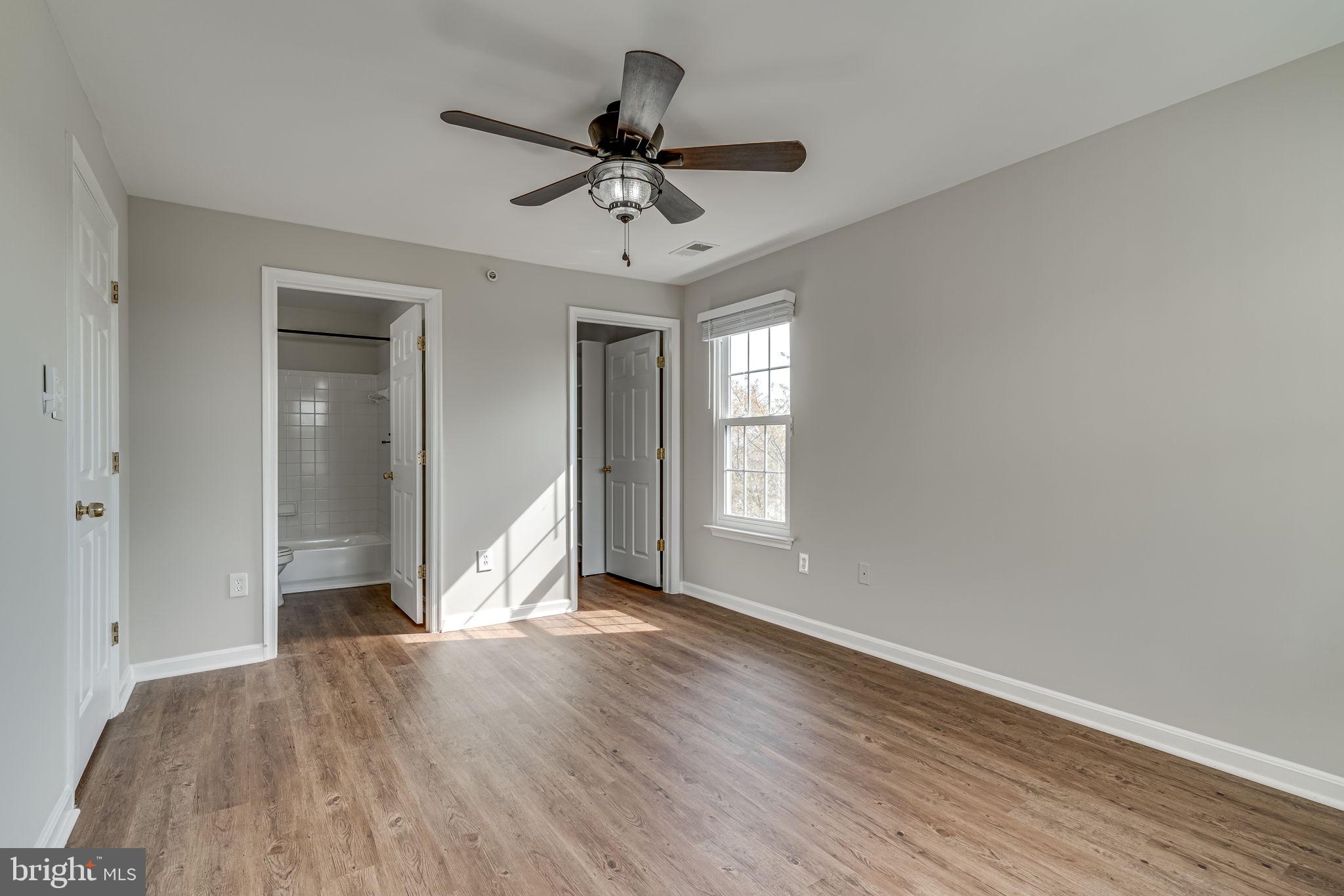 1067 Gardenview Loop, Unit 304 Woodbridge, VA 22191 - Photo 20 of 36 a view of empty room with wooden floor and fan