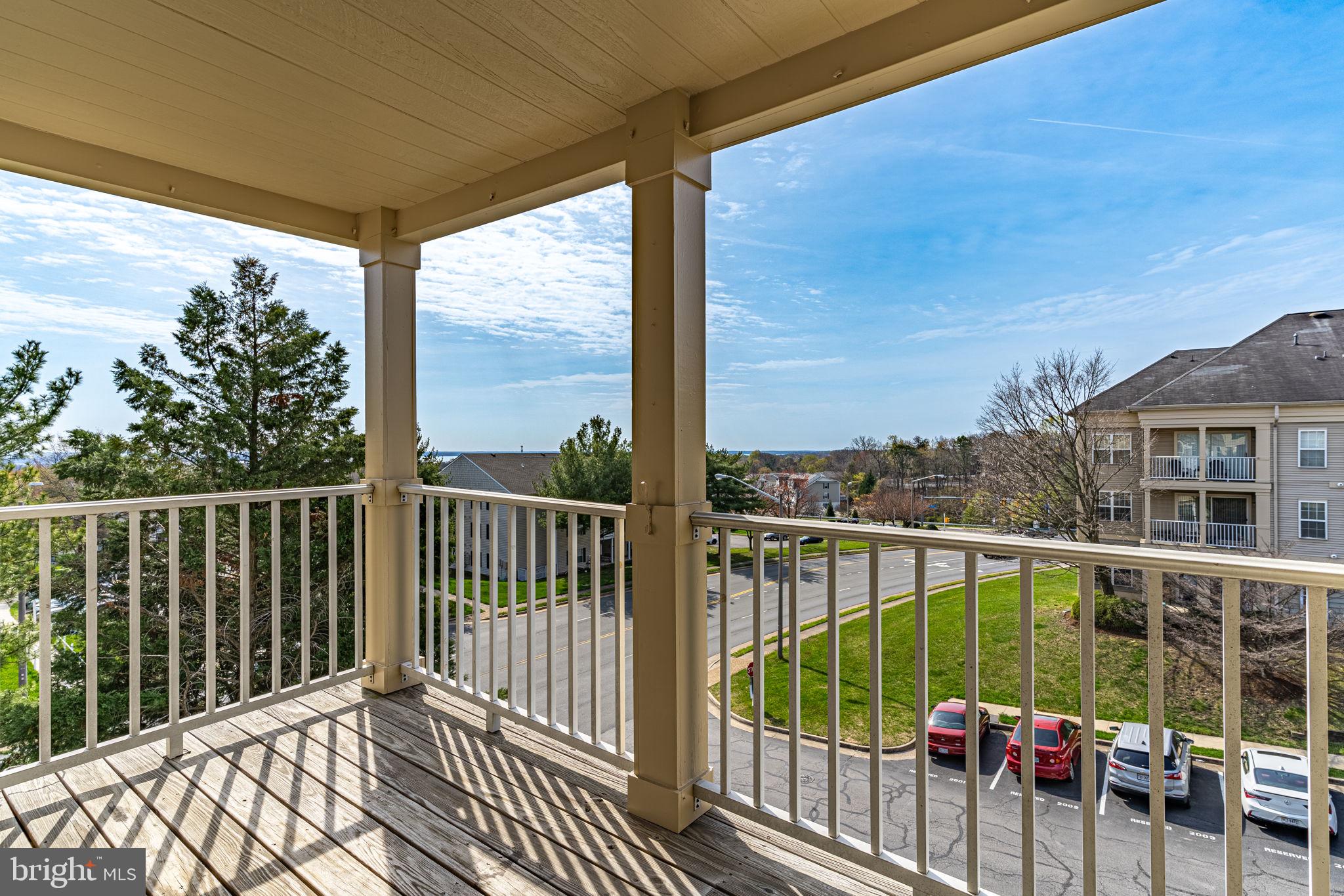 1067 Gardenview Loop, Unit 304 Woodbridge, VA 22191 - Photo 2 of 36 a view of a balcony with floor to ceiling window wooden floor