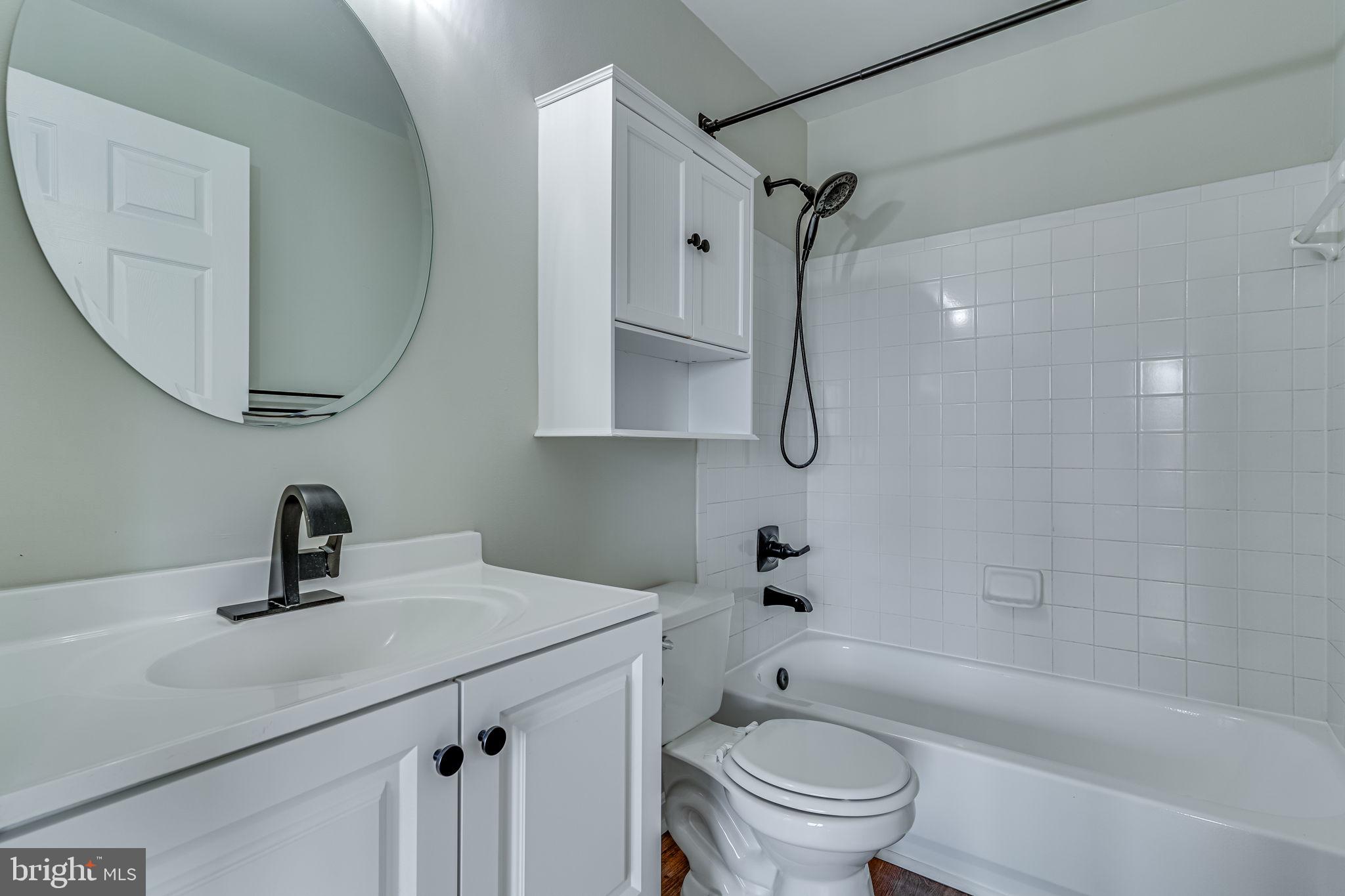 1067 Gardenview Loop, Unit 304 Woodbridge, VA 22191 - Photo 21 of 36 a bathroom with a sink a toilet and a mirror