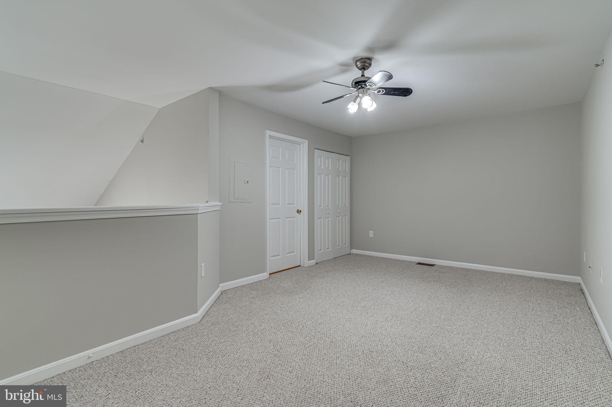1067 Gardenview Loop, Unit 304 Woodbridge, VA 22191 - Photo 23 of 36 a view of an empty room with a fan