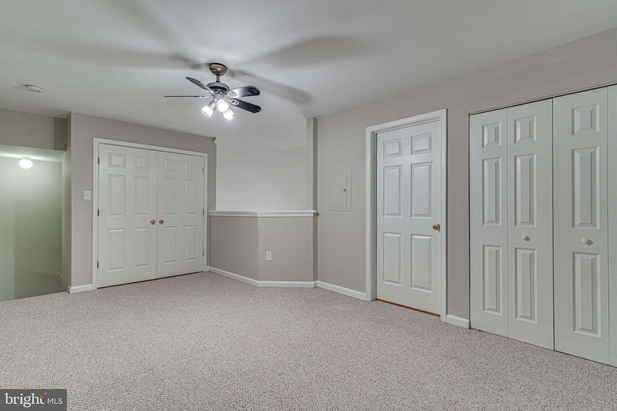1067 Gardenview Loop, Unit 304 Woodbridge, VA 22191 - Photo 24 of 36 a view of an empty room and a ceiling fan