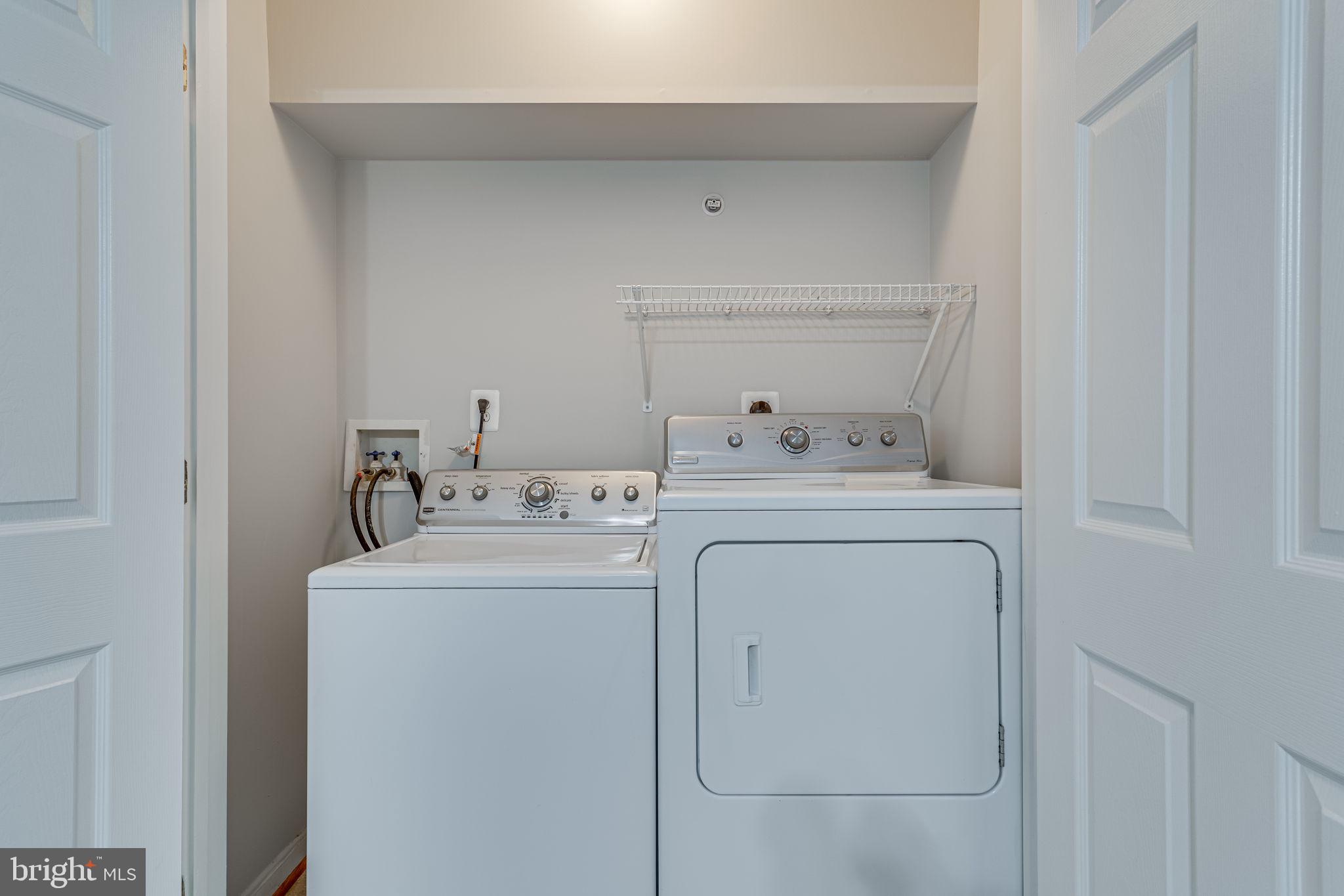 1067 Gardenview Loop, Unit 304 Woodbridge, VA 22191 - Photo 26 of 36 a utility room with dryer and washer