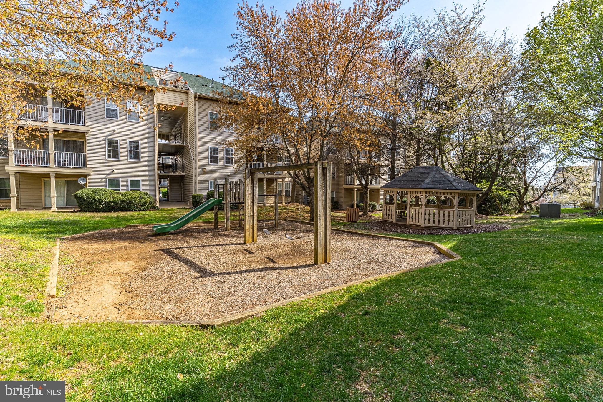 1067 Gardenview Loop, Unit 304 Woodbridge, VA 22191 - Photo 30 of 36 a view of a house with a yard