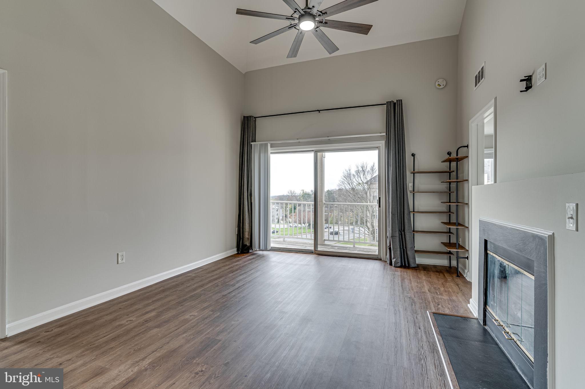 1067 Gardenview Loop, Unit 304 Woodbridge, VA 22191 - Photo 4 of 36 wooden floor in an empty room with a fireplace