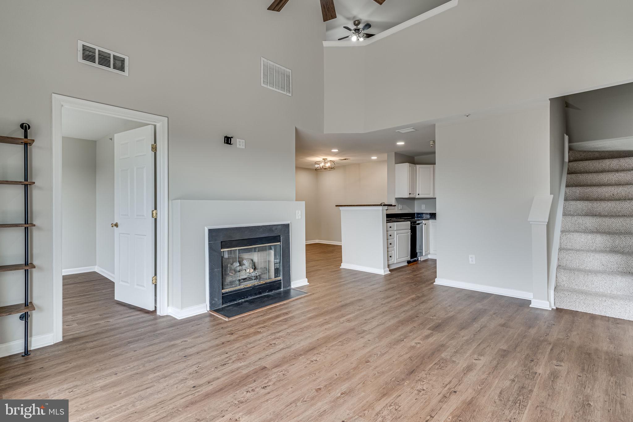 1067 Gardenview Loop, Unit 304 Woodbridge, VA 22191 - Photo 5 of 36 a view of kitchen and hall with wooden floor