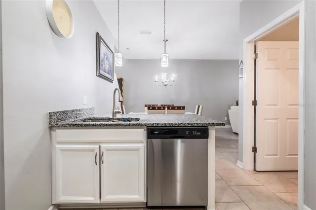 a kitchen with stainless steel appliances granite countertop a stove and a sink