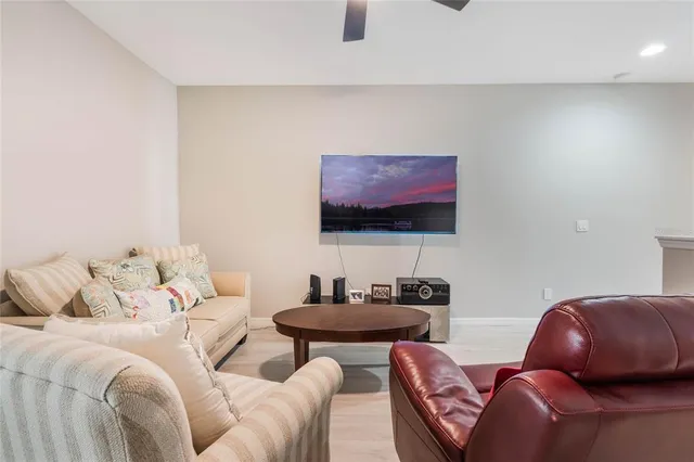 a living room with furniture a couch and a flat screen tv