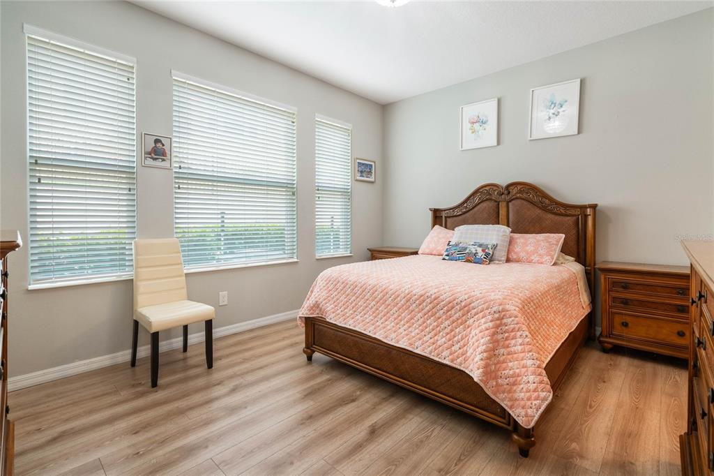 17523 Promenade Drive Clermont, FL 34711 - Photo 17 of 44 a bedroom with a bed and a chair