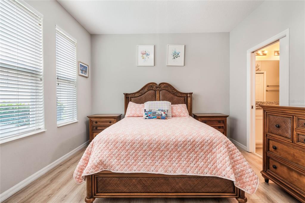 17523 Promenade Drive Clermont, FL 34711 - Photo 18 of 44 a bedroom with a bed and wooden floor