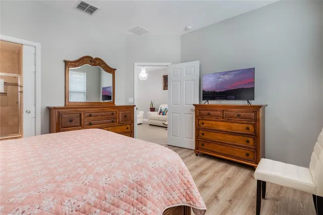 a room with a bed and a television