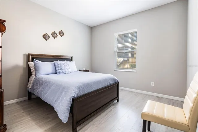 a bed sitting in a bedroom next to a window