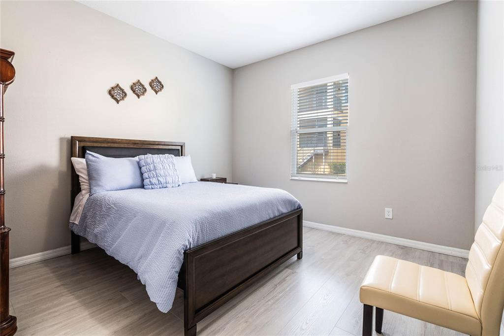 17523 Promenade Drive Clermont, FL 34711 - Photo 21 of 44 a bed sitting in a bedroom next to a window