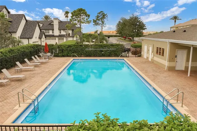 a view of swimming pool with outdoor seating and plants