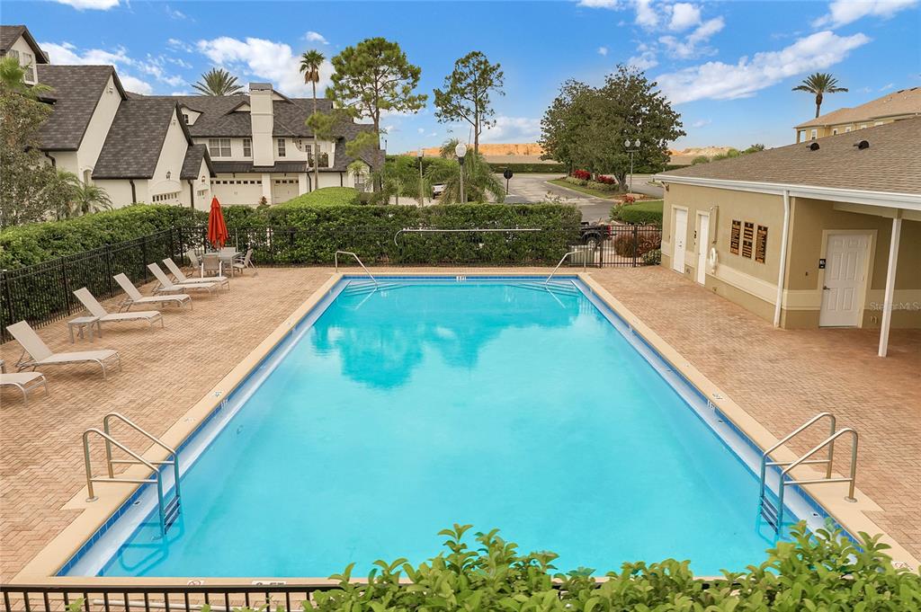 17523 Promenade Drive Clermont, FL 34711 - Photo 34 of 44 a view of swimming pool with outdoor seating and plants