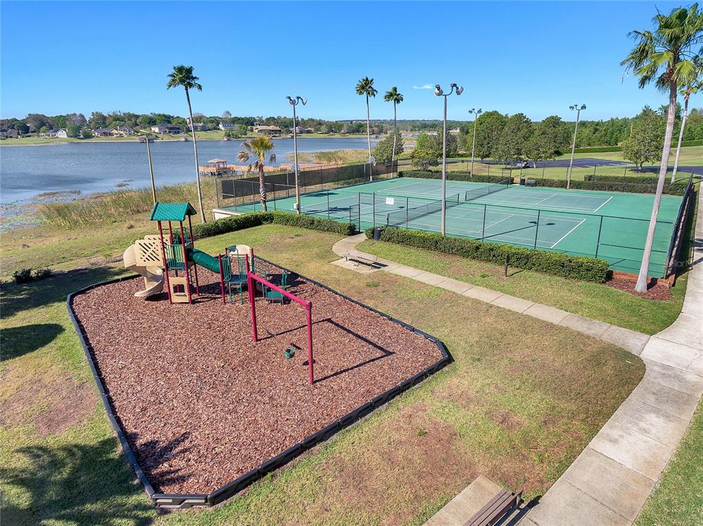 17523 Promenade Drive Clermont, FL 34711 - Photo 39 of 44 a view of a swimming pool with a lounge chairs