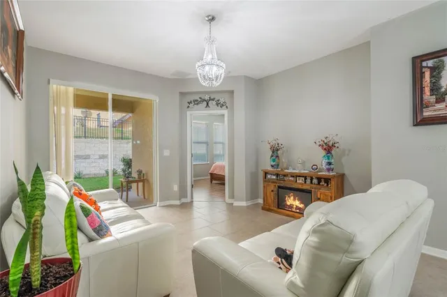 a living room with furniture and a dining table with outer view