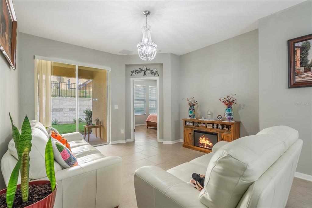 17523 Promenade Drive Clermont, FL 34711 - Photo 5 of 44 a living room with furniture and a dining table with outer view