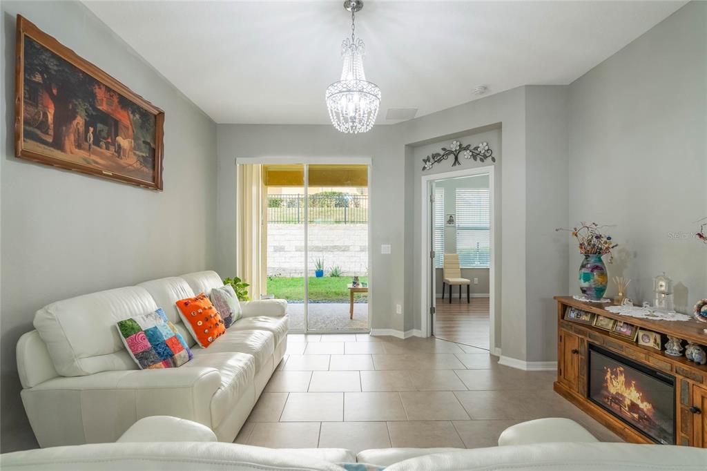 17523 Promenade Drive Clermont, FL 34711 - Photo 6 of 44 a living room with furniture and a table