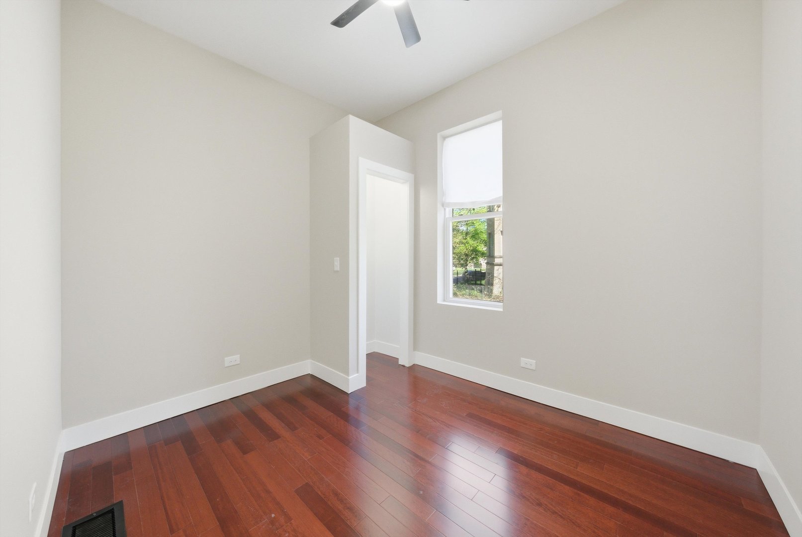 7017 South Normal Boulevard Chicago, IL 60621 - Photo 13 of 23 an empty room with wooden floor and windows