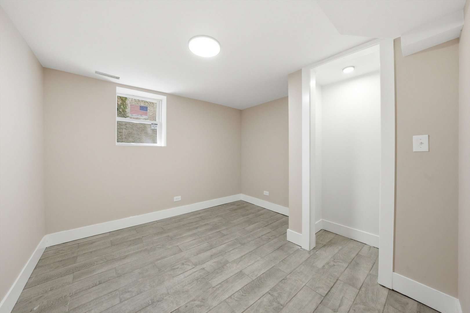 7017 South Normal Boulevard Chicago, IL 60621 - Photo 17 of 23 an empty room with wooden floor and windows