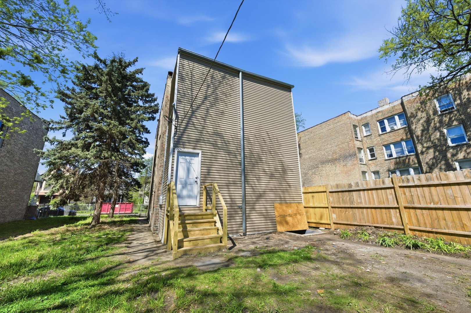7017 South Normal Boulevard Chicago, IL 60621 - Photo 19 of 23 a view of a backyard with plants and a bench