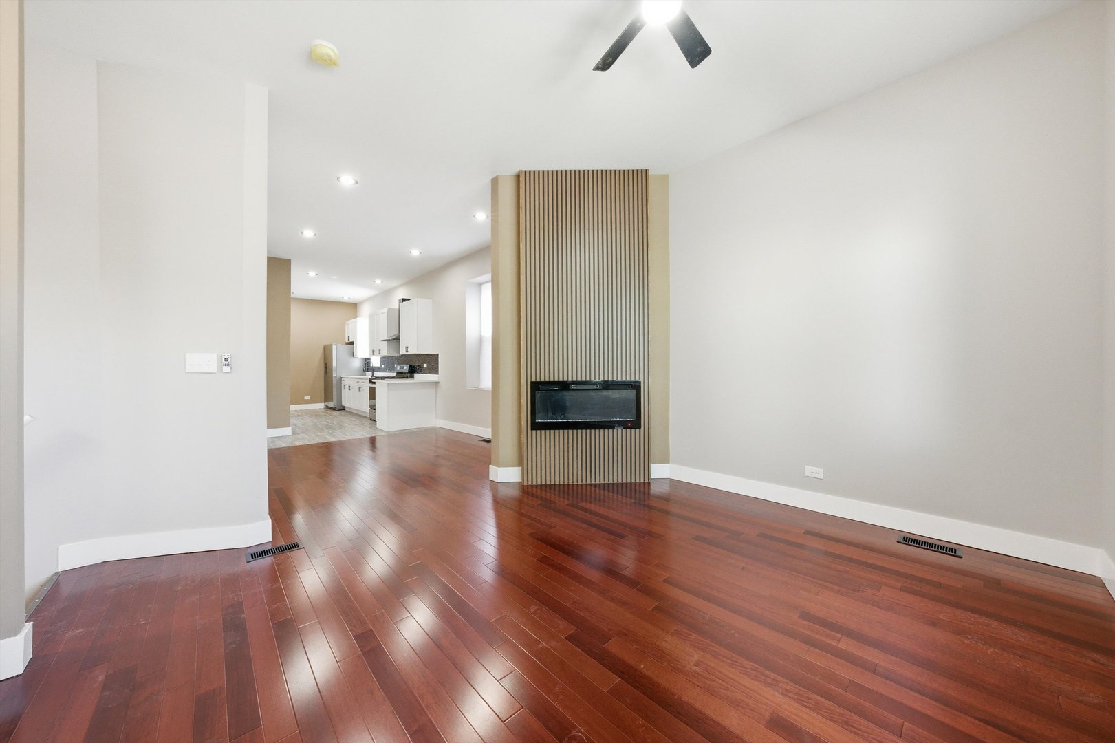 7017 South Normal Boulevard Chicago, IL 60621 - Photo 5 of 23 a view of a livingroom with hardwood floor and a ceiling fan