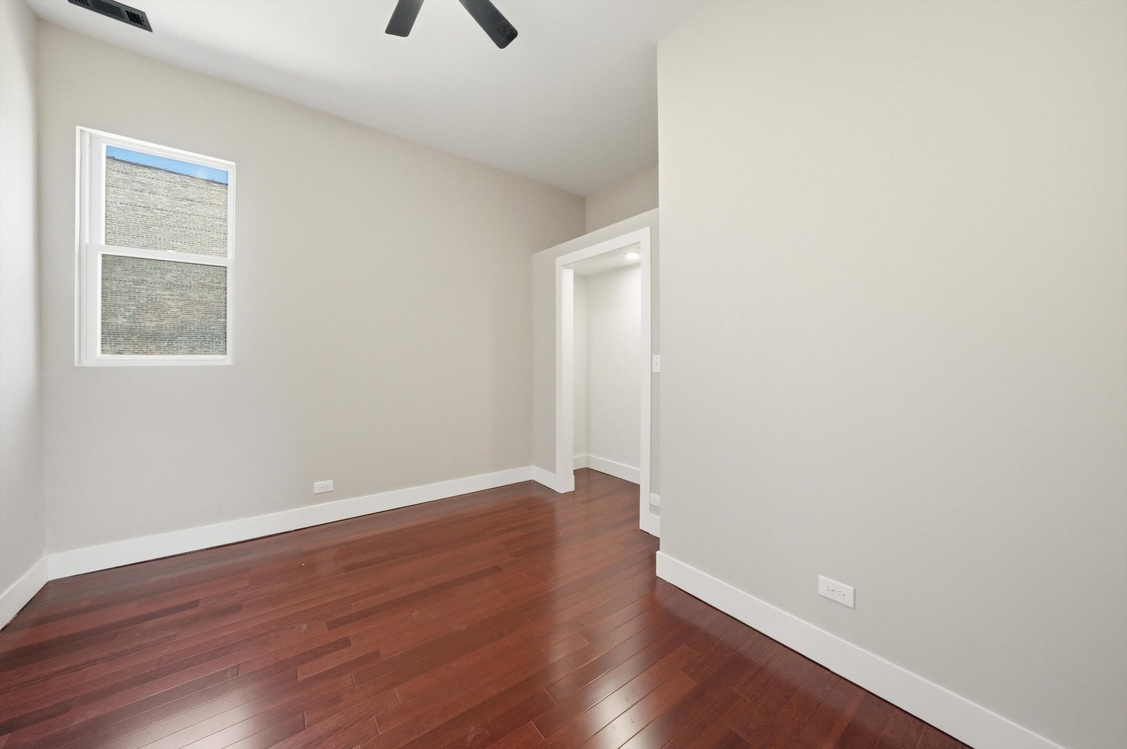 7017 South Normal Boulevard Chicago, IL 60621 - Photo 10 of 23 an empty room with wooden floor and windows