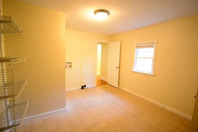 an empty room with a empty space and windows