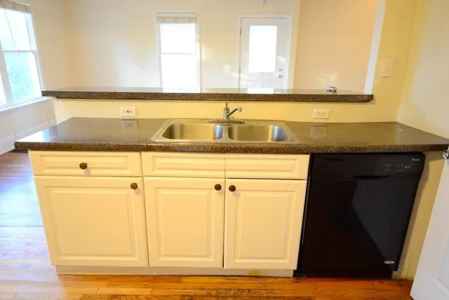 a view of a kitchen with wooden floor