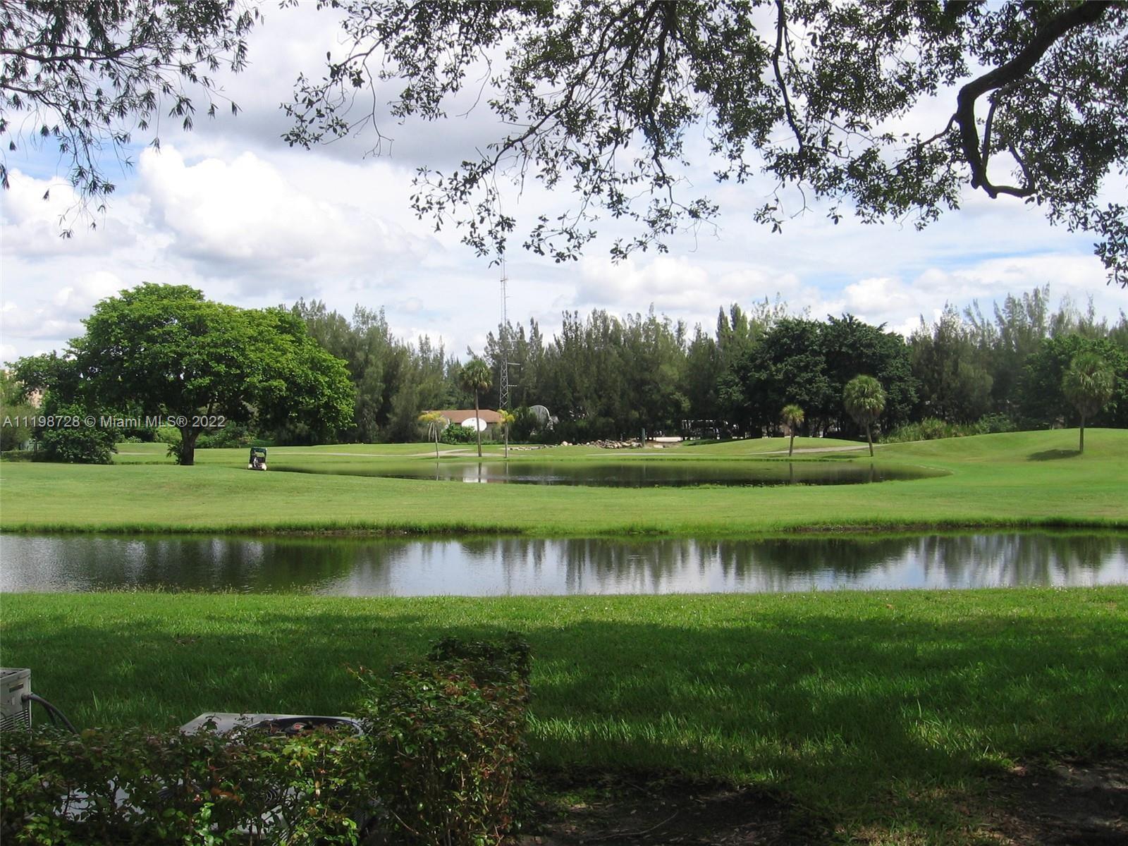 a view of a golf course of a lake