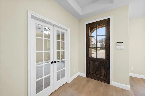 a view of a livingroom with a fireplace a ceiling fan and wooden floor