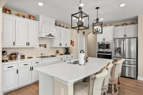 a kitchen with stainless steel appliances and white cabinets